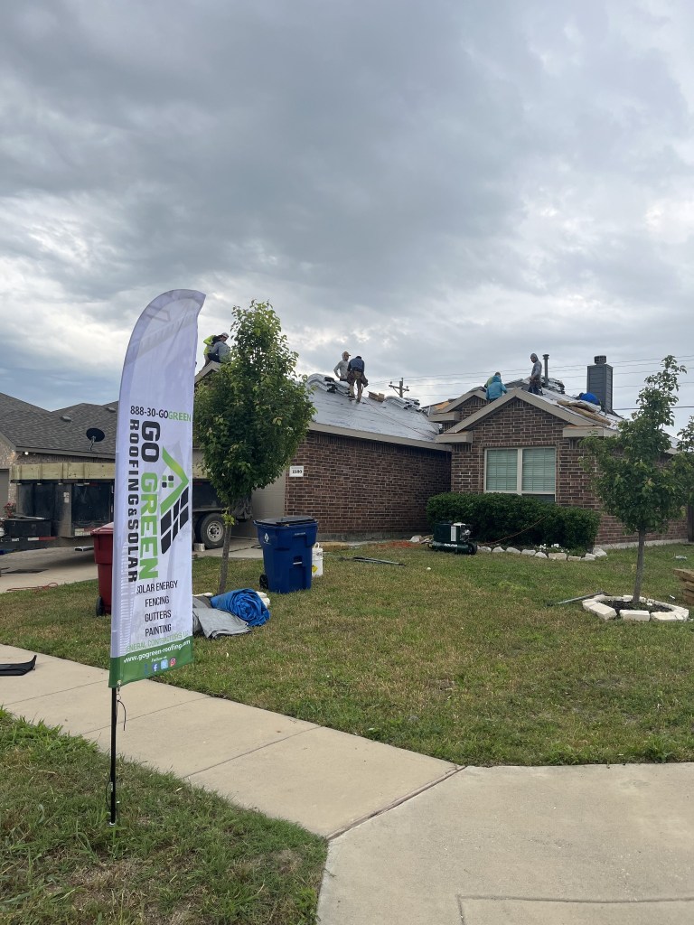 Roofing crew working on a residential roof