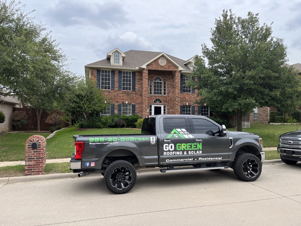 Go Green Roofing branded truck at a residential project