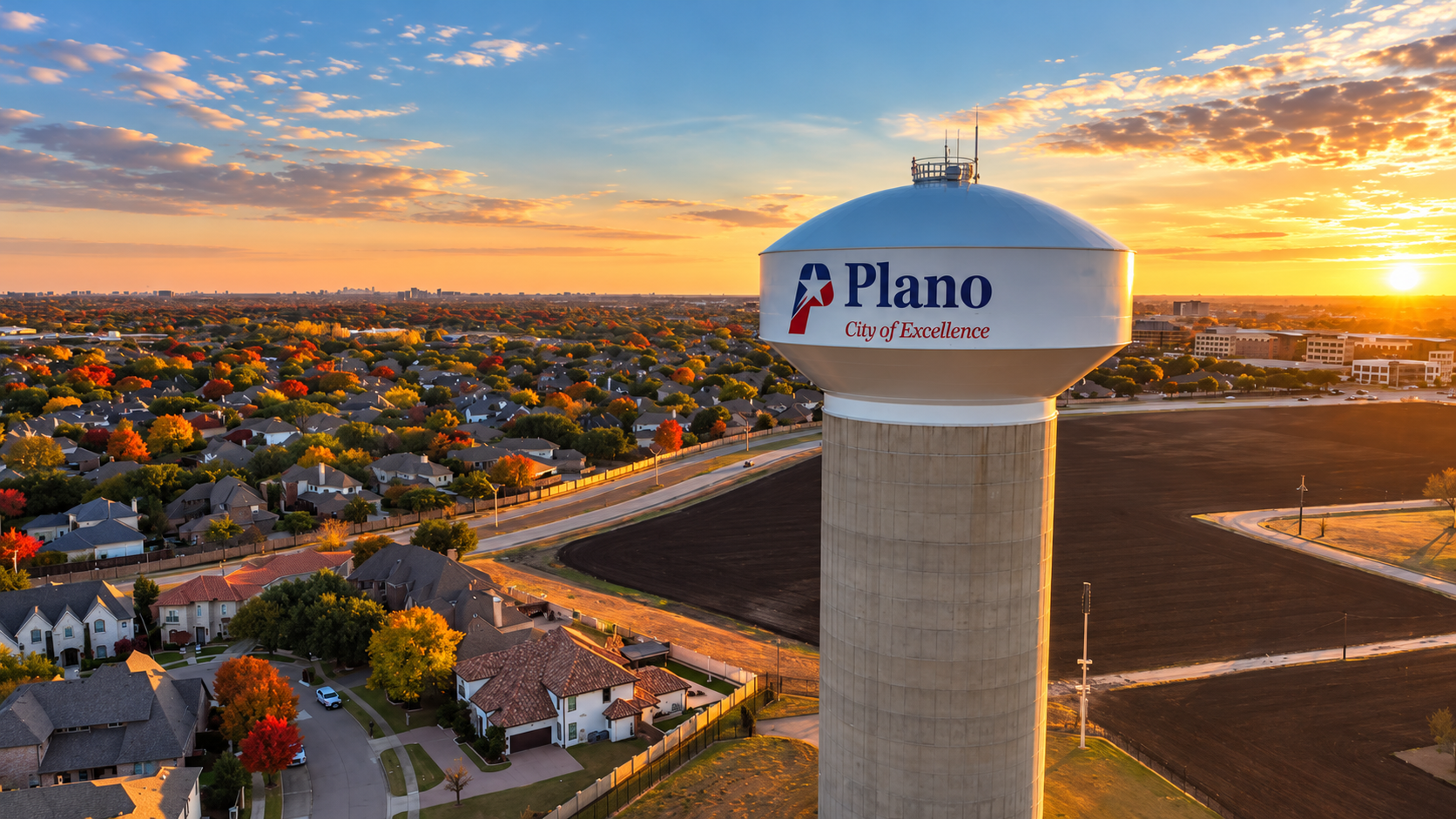 Plano, Texas water tower overlooking nearby neighborhoods at sunset