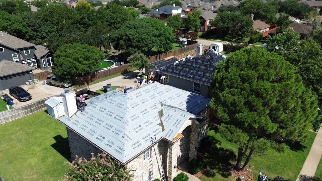 Aerial view of an active Go Green Roofing installation
