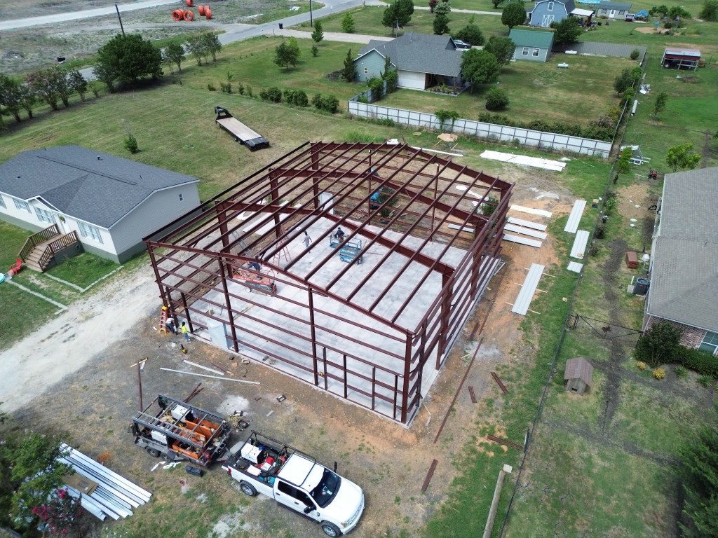 Aerial view of the red steel warehouse frame during construction